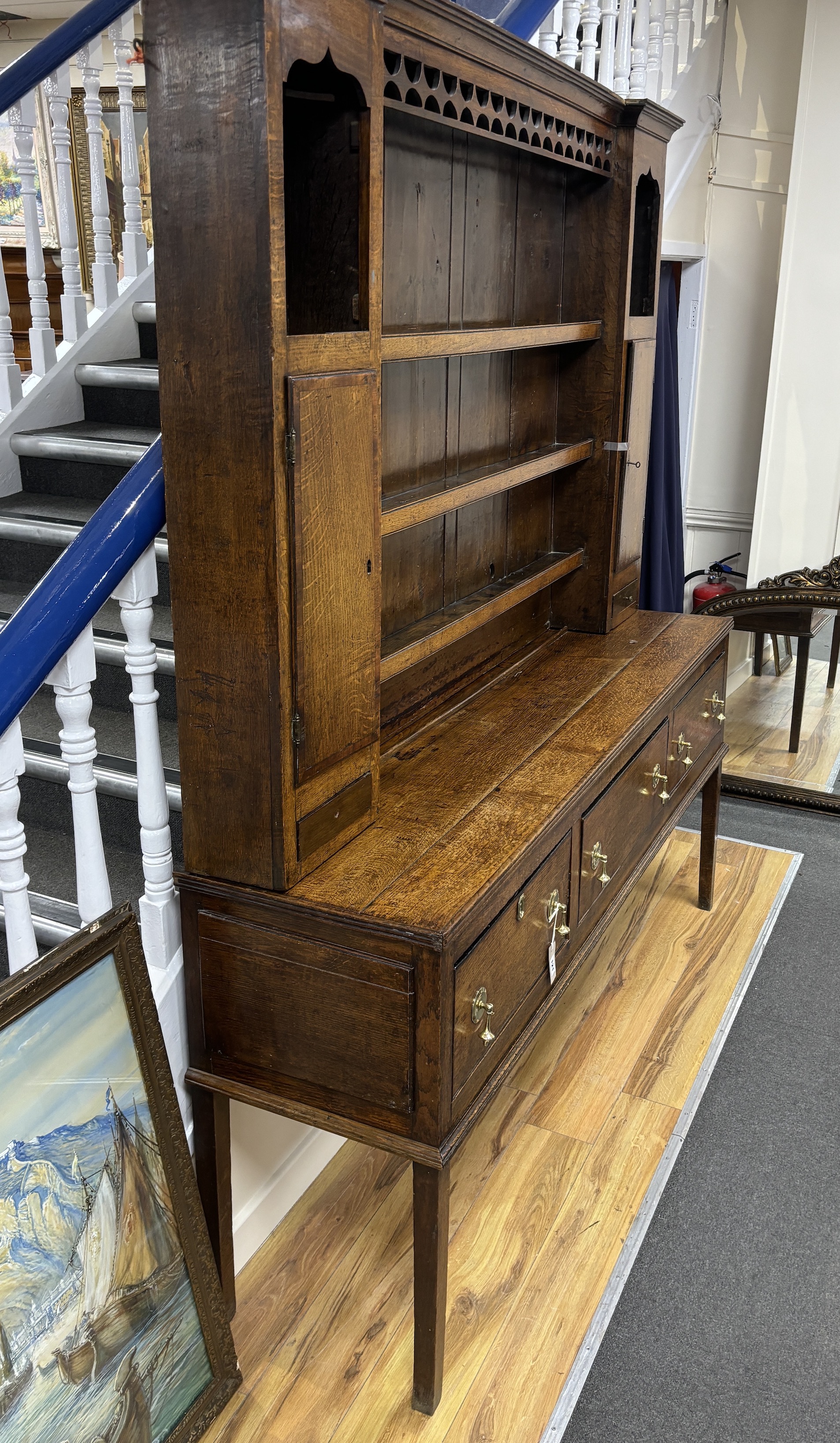 An 18th century oak dresser with boarded rack, width 182cm, depth 45cm, height 211cm